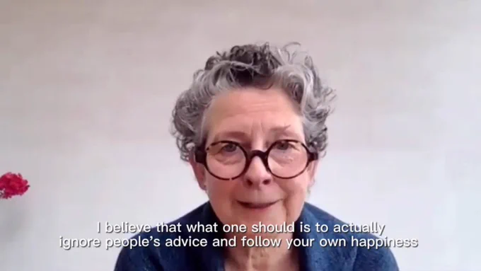 Screenshot of older person, caption "I believe that what one should do is to actually ignore people's advice and follow your own happiness"