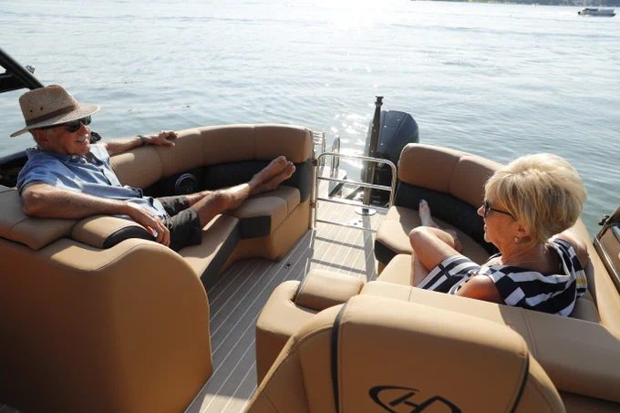 Couple relaxing on a Harris pontoon boat