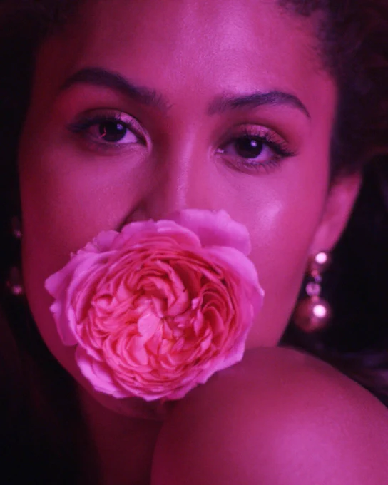 Leyna Bloom with rose in mouth