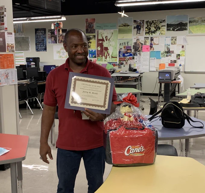 Mr. Broils with his award and basket of Canes swag!