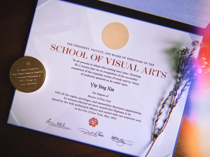 Graduation certificate from School of Visual Arts MFA, with the Paula Rhodes Memorial Award and some dried flowers on the side.