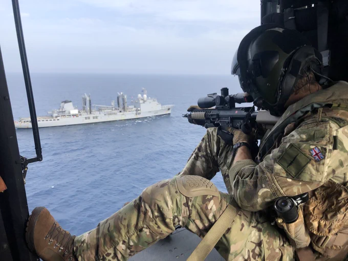 A commando from 42 Commando provides overwatch during a boarding exercise alongside allies