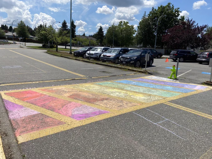 School crosswalk coloured in pride flag colours.
