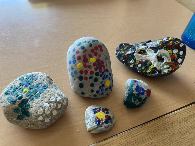 Rocks painted in Métis style dot art.