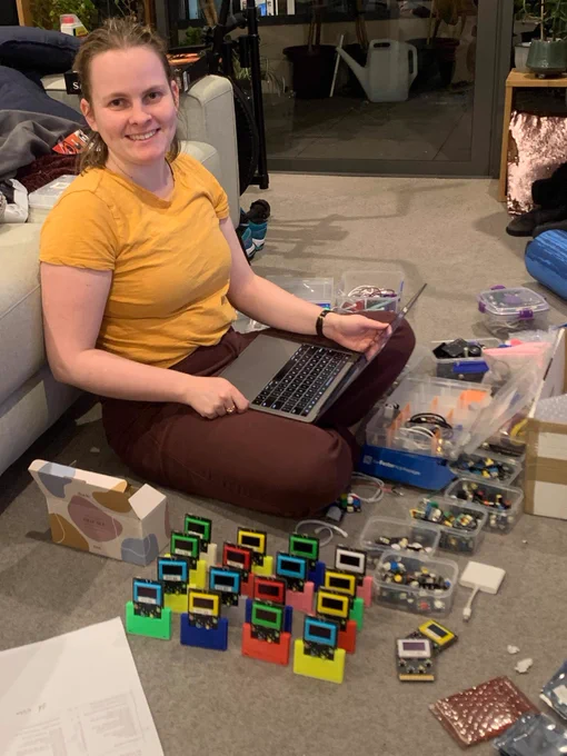 Me surrounded by piles of tech and electronic components. 