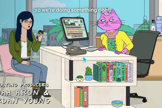A screenshot from the animated show Bojack Horseman showing a desk full of books. On one side, a pink humanoid cat with arms is glaring at an Asian woman with a phone, who is sitting across from her. The closed captions read "so we're doing something right."