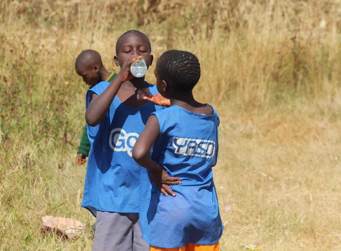 Young people taking a water break during a @Yasdzim sports training session. The training session are a safe space where young people are mentored and trained in health, economic and social issues.