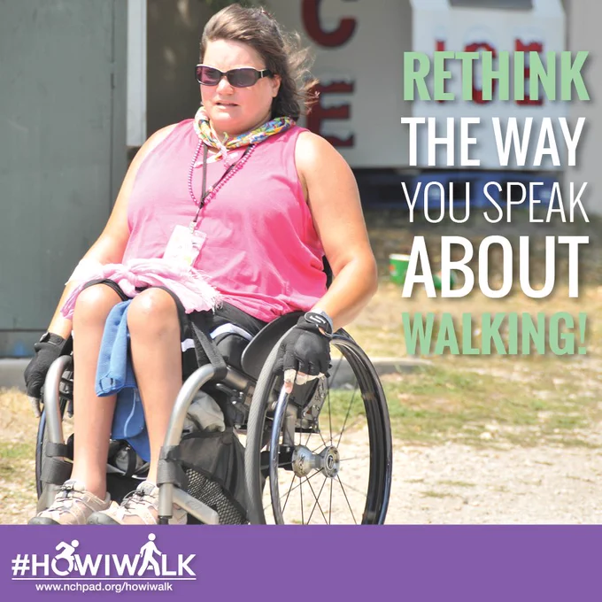 A lady with brown hair is in a pink sleeveless t-shirt out walking in her wheelchair on a bright sunny day. She has a towel on her lap and gloves on her hands.  The text on top of the image reads: “Rethink the way you speak about walking!”.