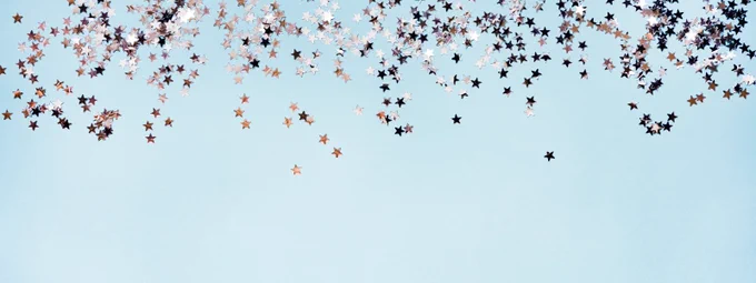 Light blue background with ~50 small silver stars at the top of the image