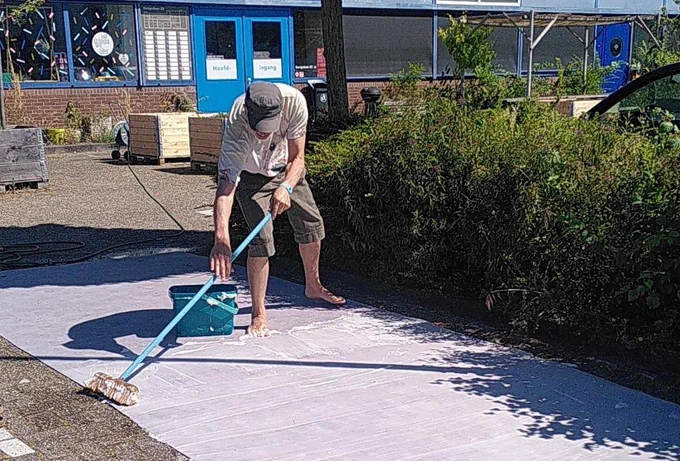 Picture of Simon bleaching floor pieces outside in the sun
