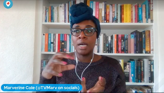 Screenshot of Marverine Cole, a Black Woman with glasses wearing a teal head wrap talking and gesturing emotively. 