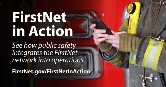 FirstNet in Action; See how public safety integrates the FirstNet network into operations; FirstNet.gov/FirstNetInAction; Fireman using his FirstNet enabled cell phone standing in front of a fire engine