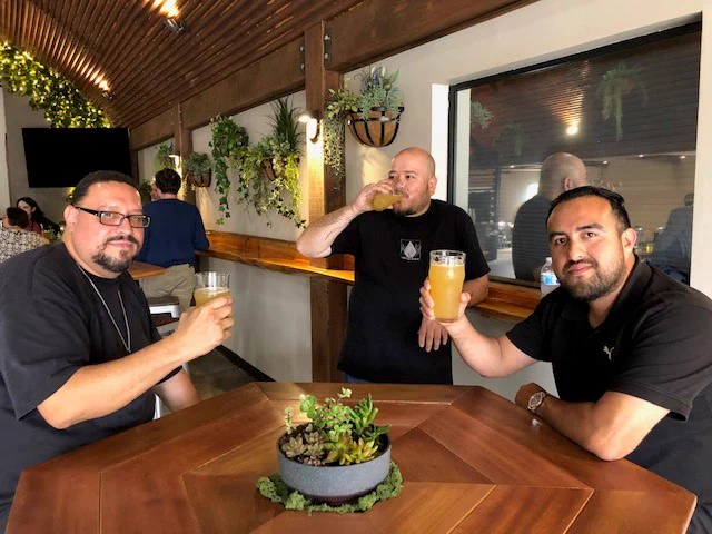 Employees enjoying time and a beer together!