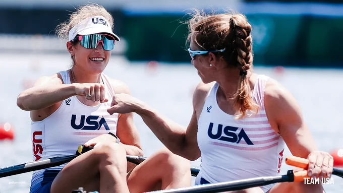 U.S. Olympic rowers Kristi Wagner and Gevvie Stone fist bump after completing their qualifying race of the women's double sculls competition.