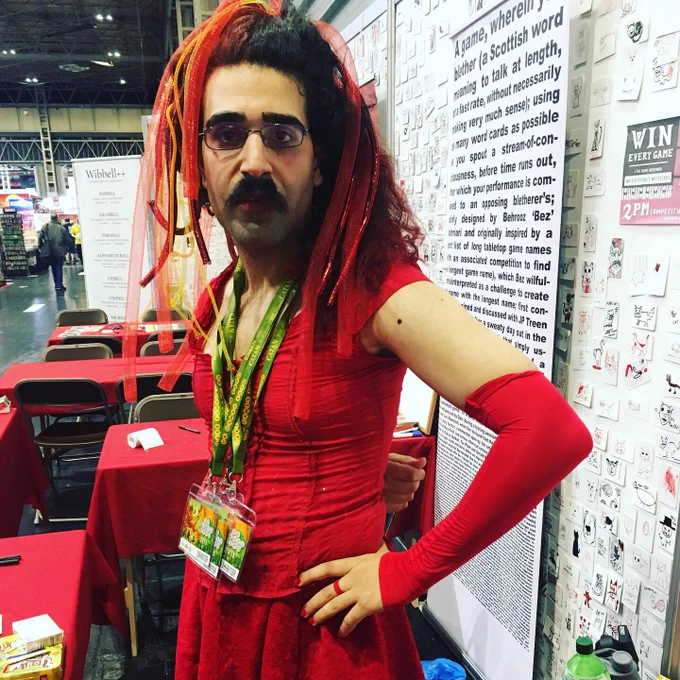 Bez, wearing red, red top, red skirt, red springy headpiece, red arm-sleeve-things.