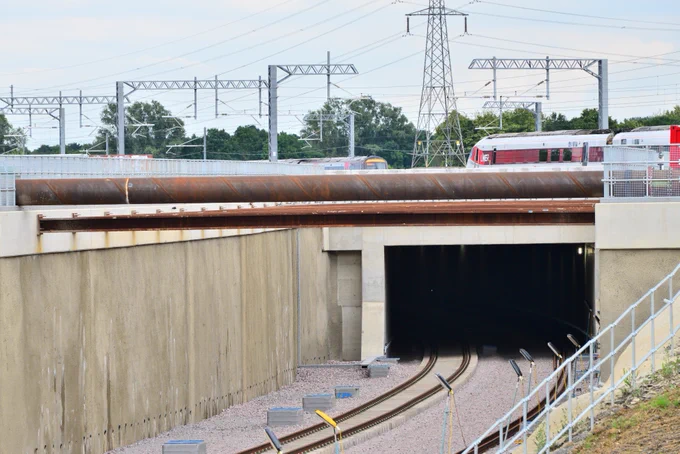 Two trains on the East Coast Main Line cross over the new railway tunnel at Werrington.