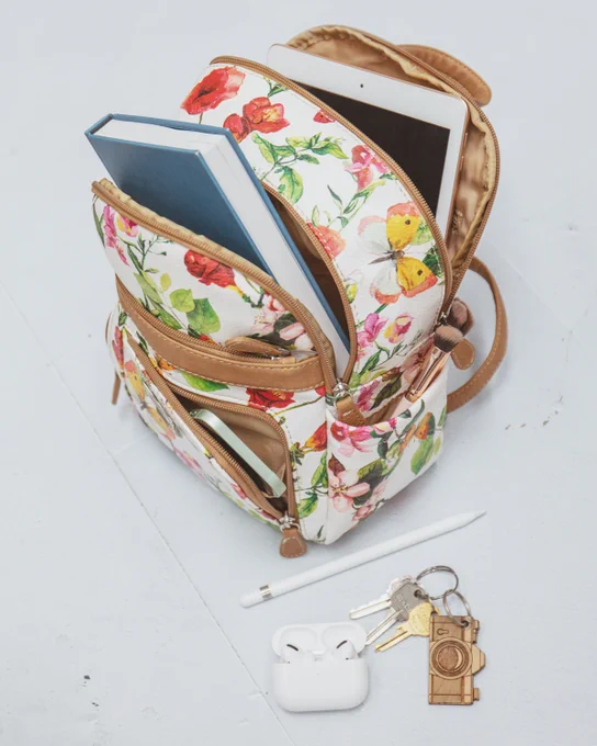 Our butterfly floral Adele Backpack holding all of the essentials that we need for the day!