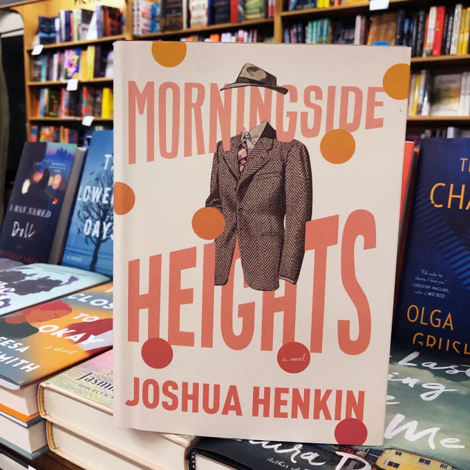 Morningside Heights: A Novel by Joshua Henkin book standing on a table full of books with a background of bookshelves in the best little bookstore in the Bay Area, Bookshop Santa Cruz.