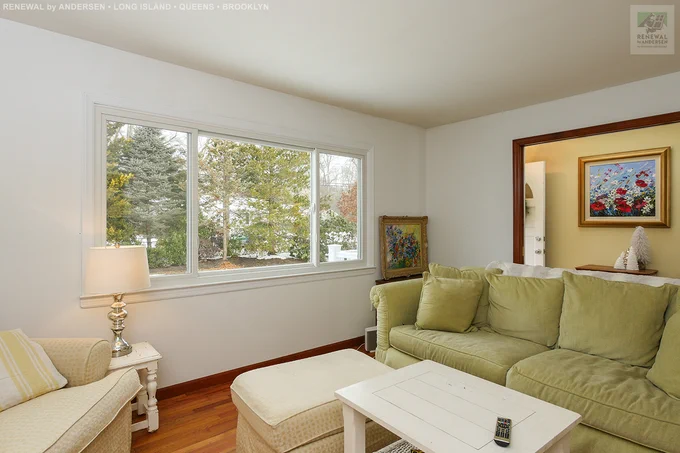 Bright and charming living room with large new sliding window we installed. This big window looks out onto the front yard and provides amazing natural light to the light and airy style of this space. Find out more about getting the windows replaced in your home from Renewal by Andersen Long Island, serving Nassau, Suffolk, Brooklyn and Queens. 