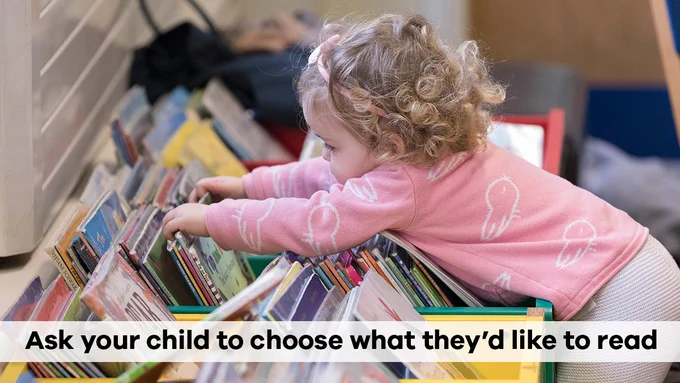 A child choosing books with the words: 'Ask your child to choose what they'd like to read'