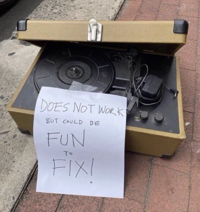 Record with sign on it that says "does not work but could be fun to fix!"