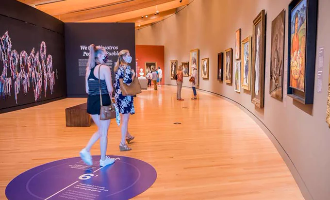 People wearing face masks at an art exhibition
