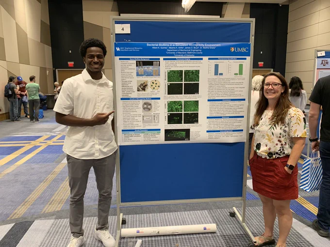 Photo of Albert Gumbs, his research poster, and advisor Dr. Grady