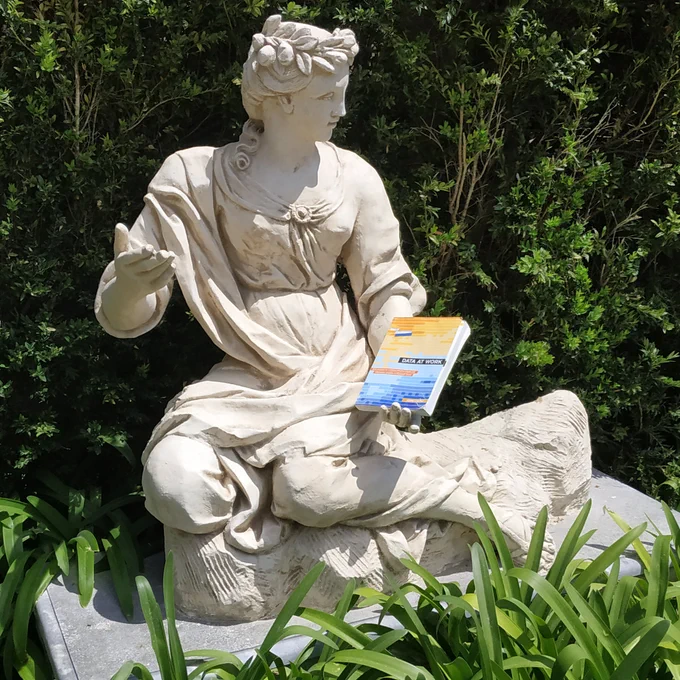 Statue holding my book, Data at work.