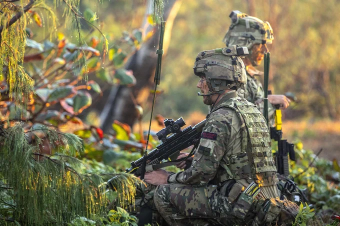 Royal Marines push inland towards Ingham amid bushes still damp with the morning dew