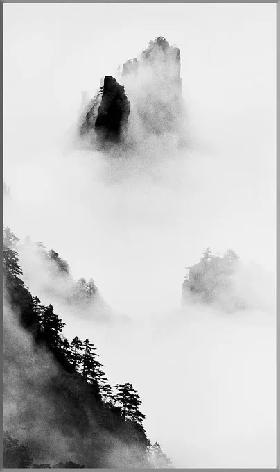 This black and white photo of Huang Shan (Yellow Mountain) in China's Anhui province was captured by Chinese photographer Wang Wusheng (1945- ).  The simplicity and the Liu Bai (blank space) give the photo the resemblance and quality of a traditional Chinese water-ink painting.
