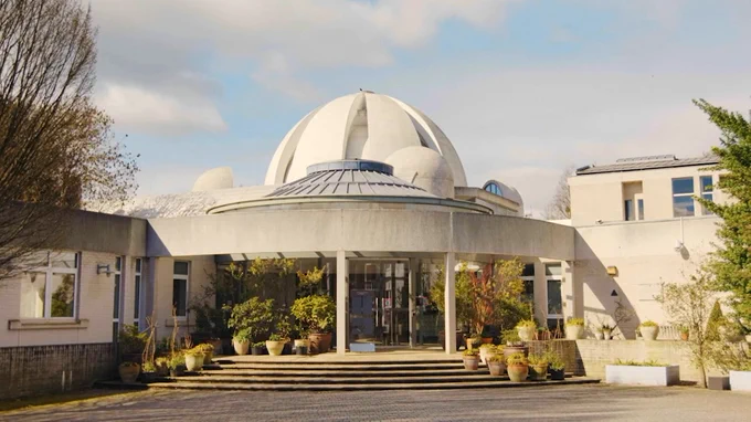 The entrance to Murray Edwards College with the Dome in the background.