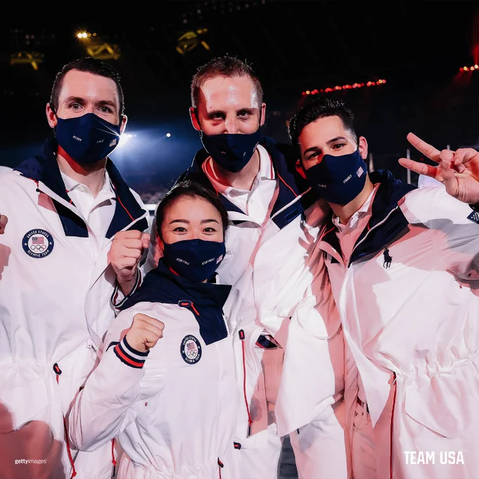 Image of the USA Karate Team posing together at the Tokyo Olympics Closing Ceremony. Four USA Kara athletes posed together wearing white Ralph Lauren outfits. 