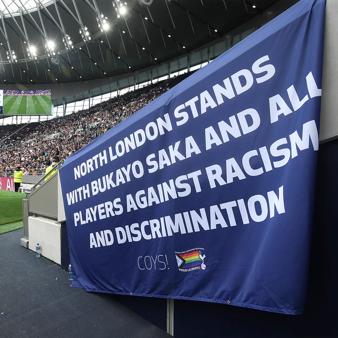 The flag reads ' North London stands with Bukayo Saka and all players against racism and discrimination '
