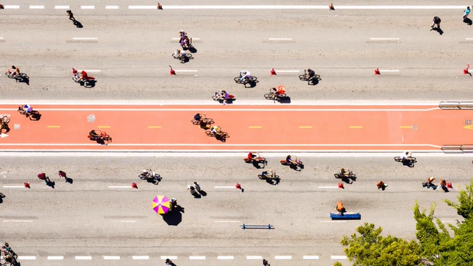 Aerial view of bicycle path full of cyclists on a sunny day