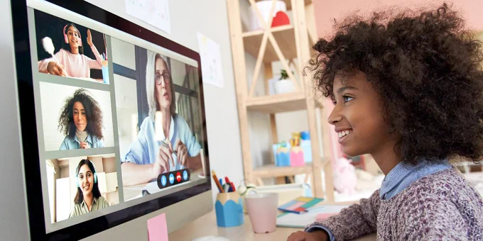 student engages in remote learning on a desktop computer with teacher