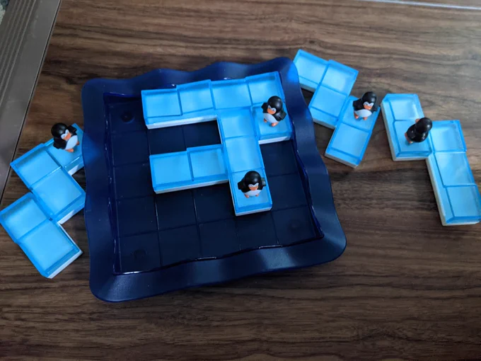 "Penguins on ice" game pieces and board on the floor partially completed.