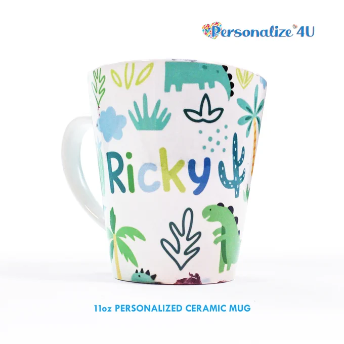 11-ounce latte mug with a personalized name inscribed on its cover, in a medley of Jurassic plants and cartoon dinosaur.