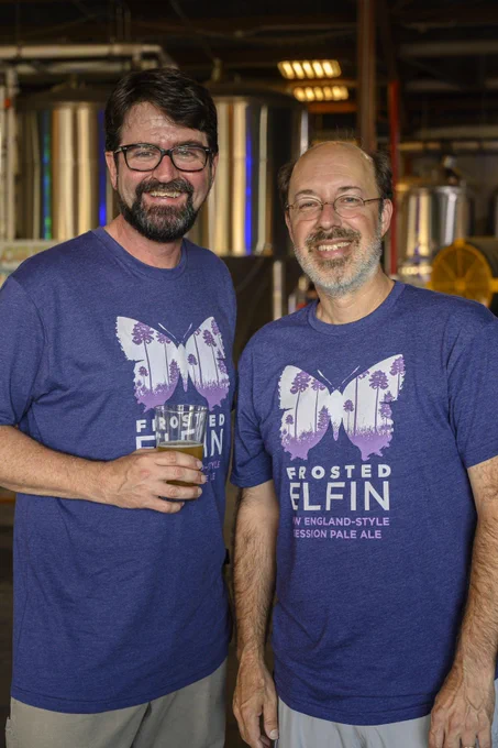 two people in butterfly t-shirts pose for a portrait