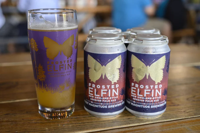 beer cans and glass with butterfly logos