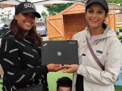 Savraj Kaur donating an unwanted laptop.