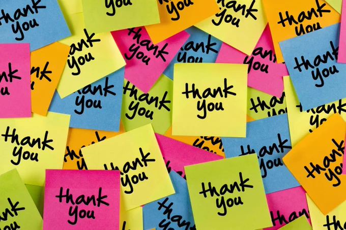 A photo of multiple, multi-coloured post it notes with the words thank-you written on each of them.