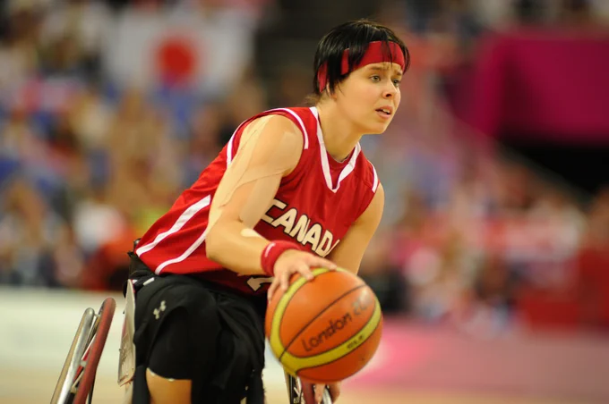 Canadian wheelchair basketball player Cindy Ouellet dribbling the ball during a game at the 2012 Paralympic Games in London.
