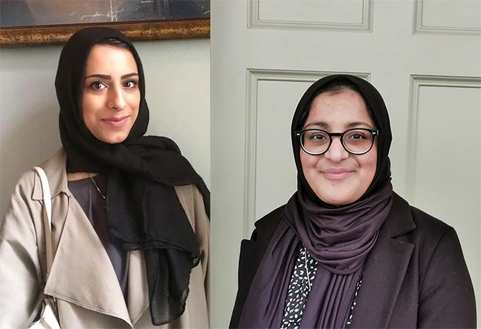 Two women standing side by side and smiling