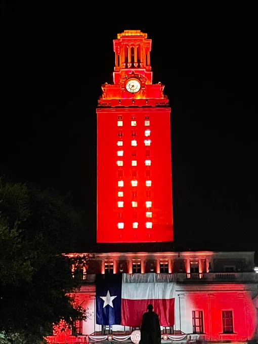 The UT Tower shines with burnt orange lights and “25” on its sides