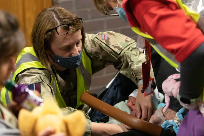 Female soldier with a small baby