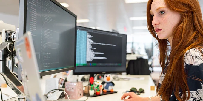 photo of a woman working at a computer in an office