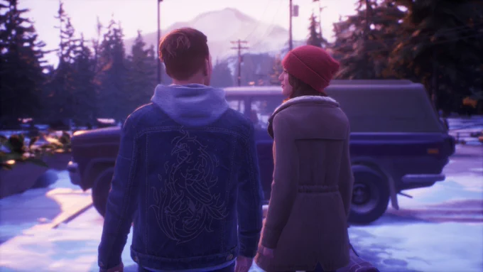 Tyler and Alyson walking to their car, with trees and mountains behind them.