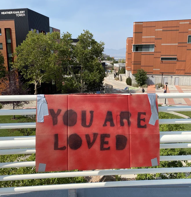 Photo of a sign that reads “you are loved” on the campus of the University of Utah