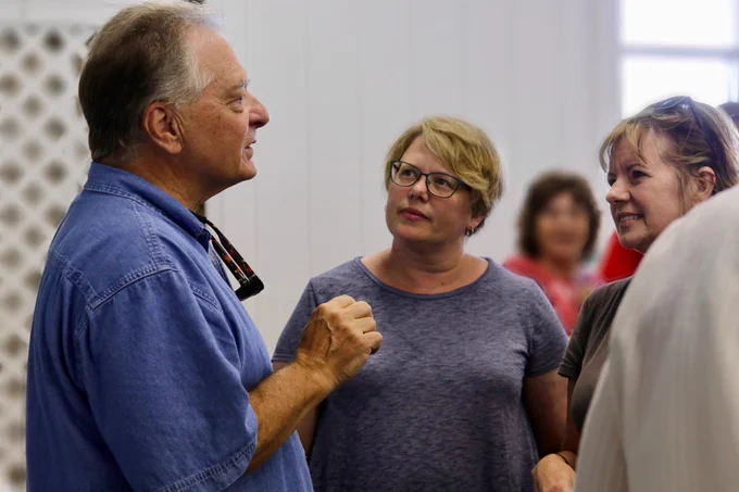 Master Gardener Steve De Carlo speaks with two attendees at the Delaware State Fair.