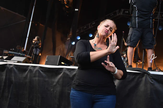 An ASL interpreter interpreting a musical performance. 
